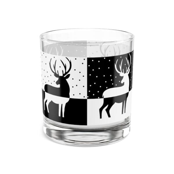 A glass with deer on it and black and white design.