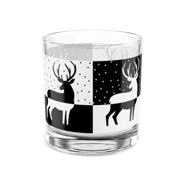 A glass with deer on it and snow in the background.