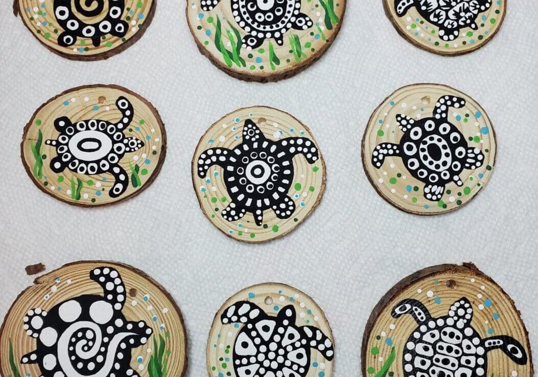 A group of wood slices with black and white designs on them.